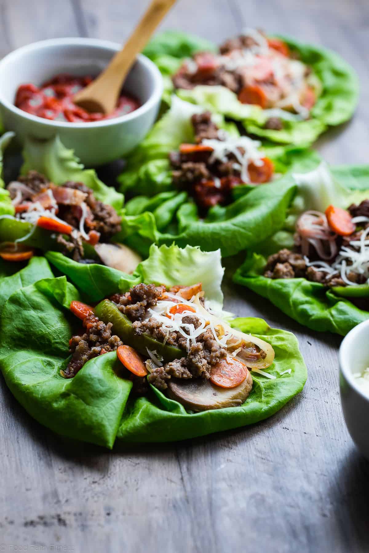 close up side view of low carb lettuce wraps on a table