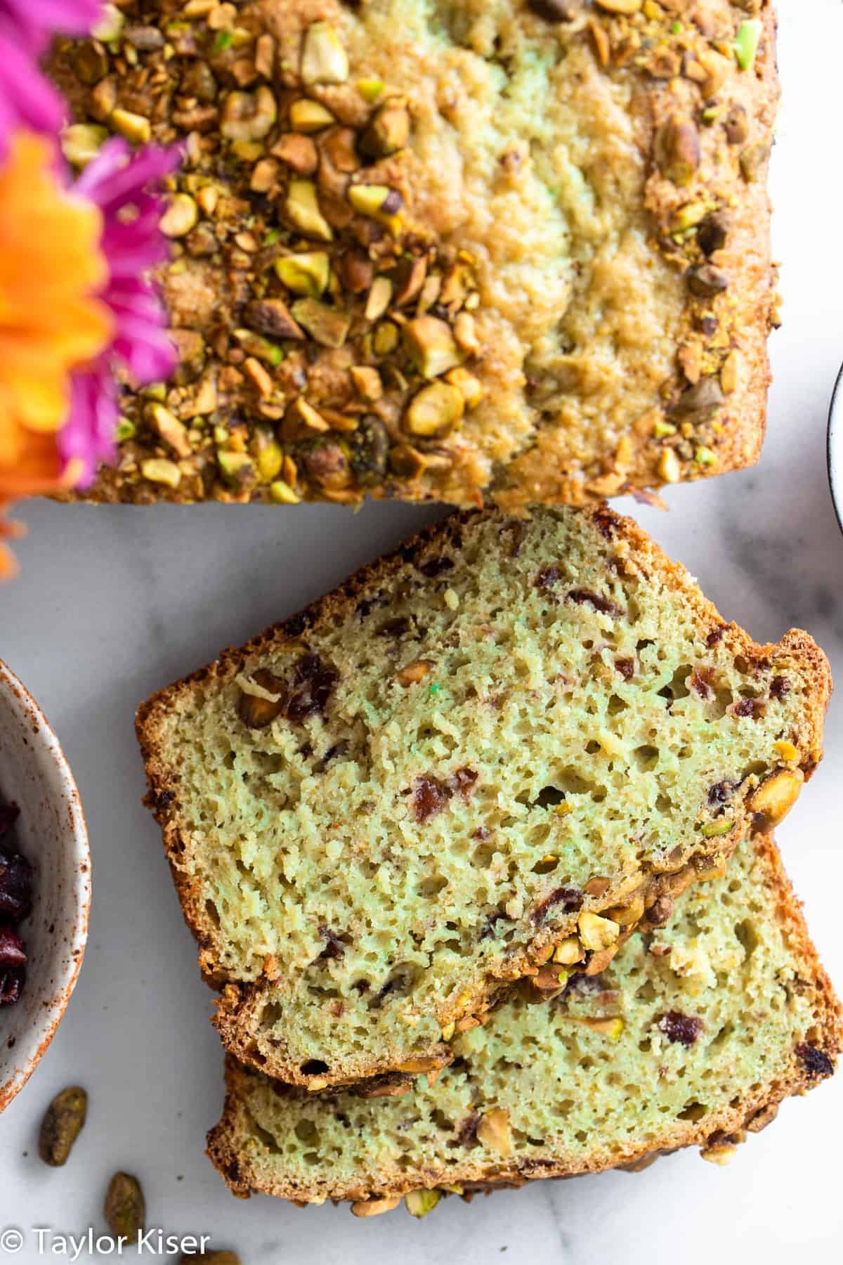 sliced green cranberry pistachio bread on a table