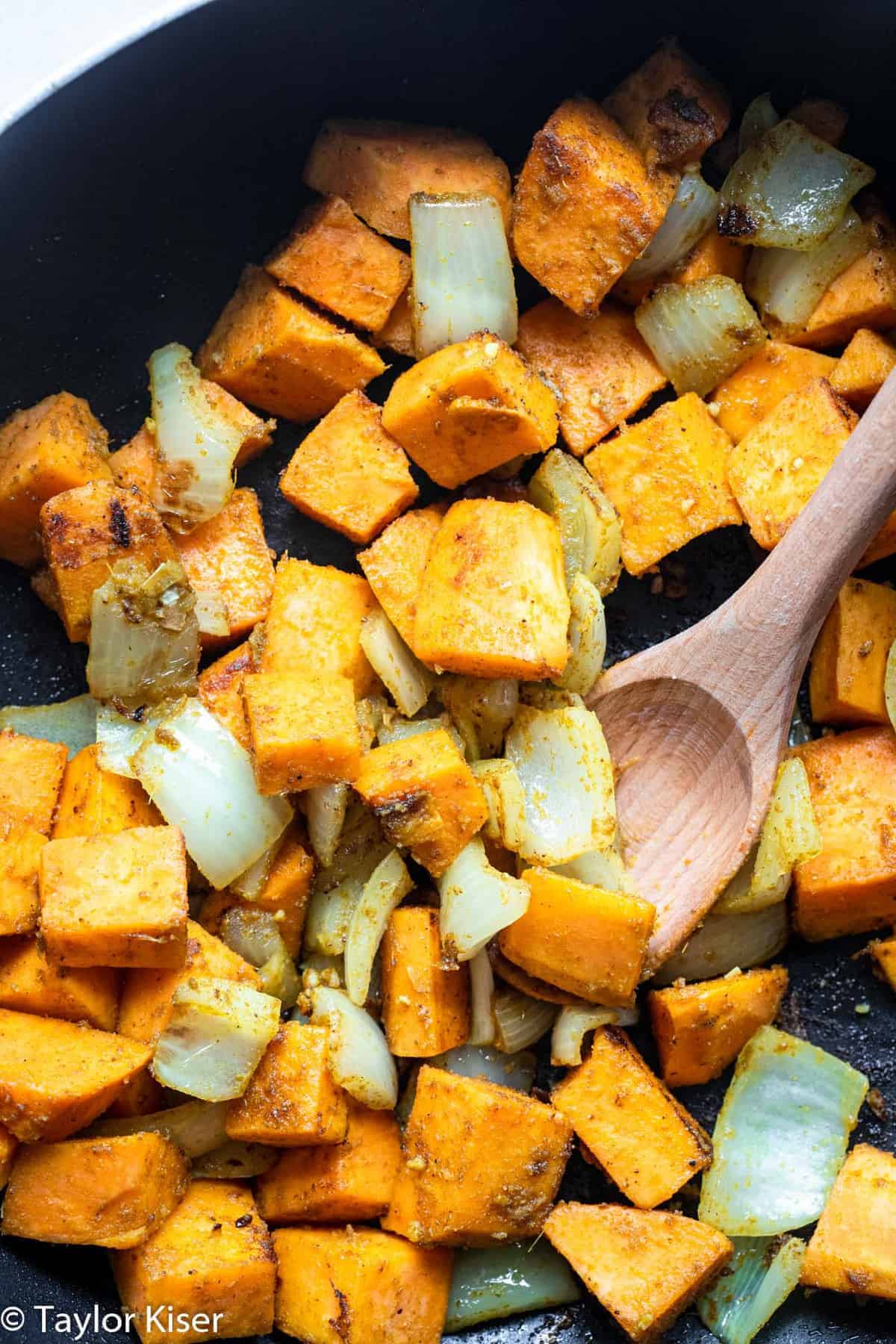 Sweet potatoes and onions in a cast iron pan
