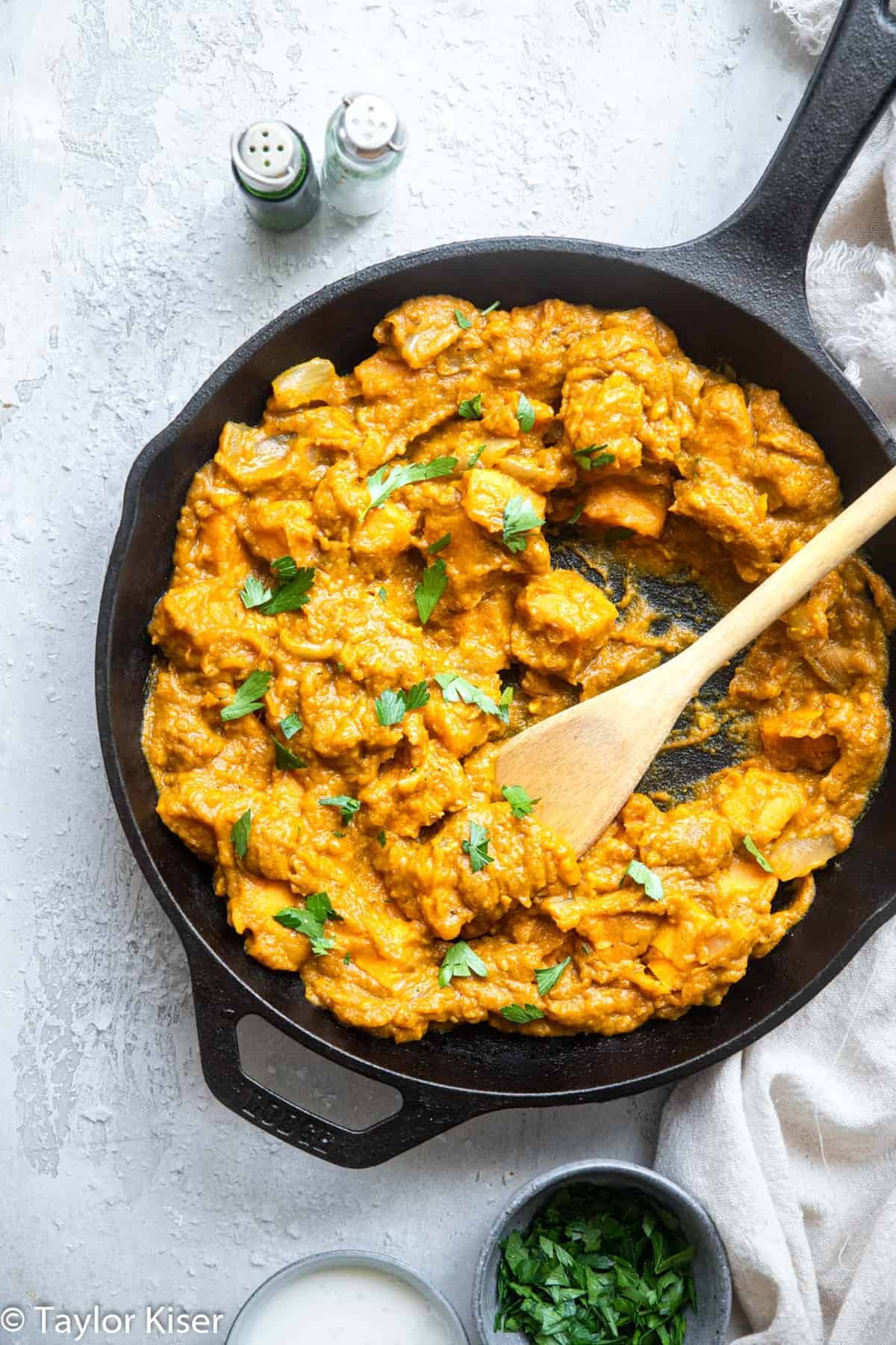 Pumpkin coconut curry in a cast iron pan