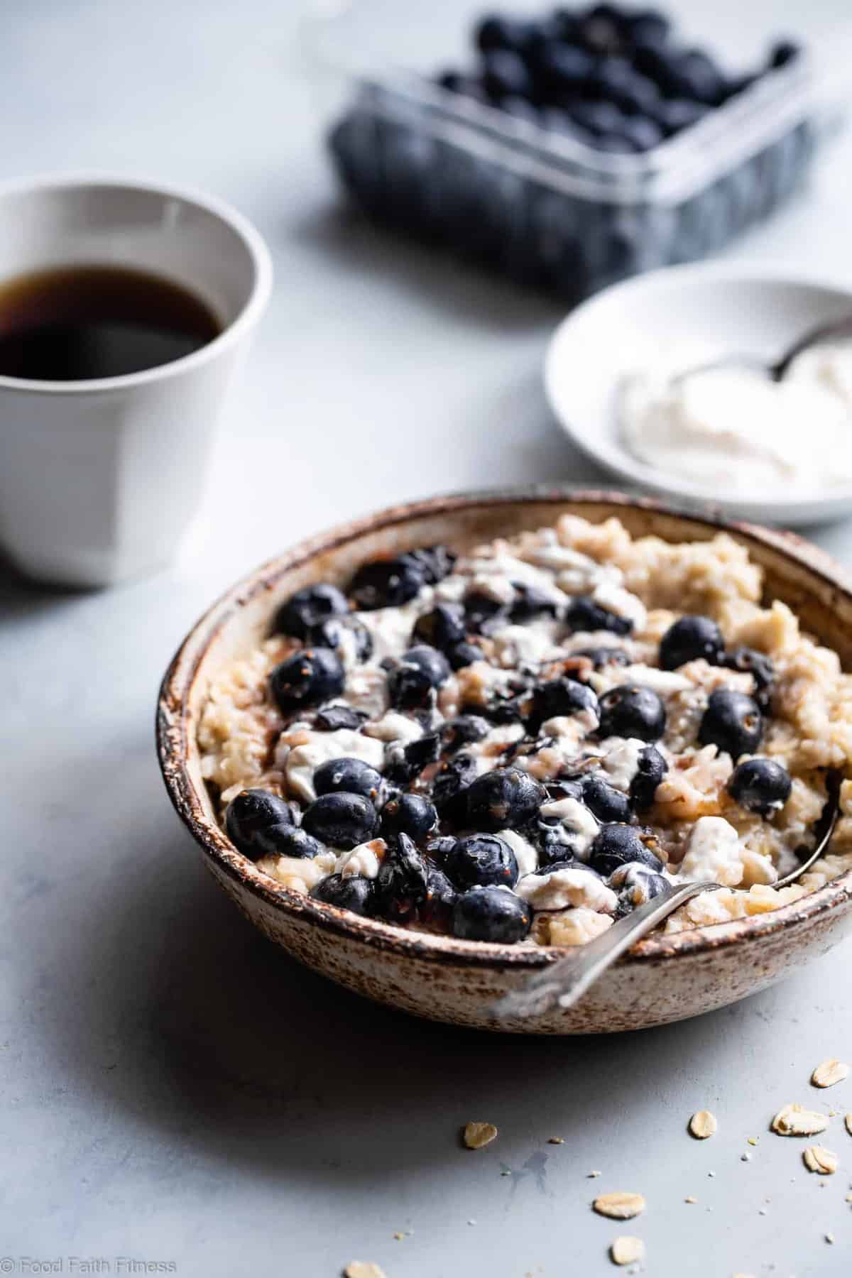 Blueberry Cheesecake Oatmeal - This quick and easy Blueberry Oatmeal with Cheesecake Swirl is a healthy, low fat and gluten free breakfast that tastes like waking up to cheesecake! | #Foodfaithfitness | 