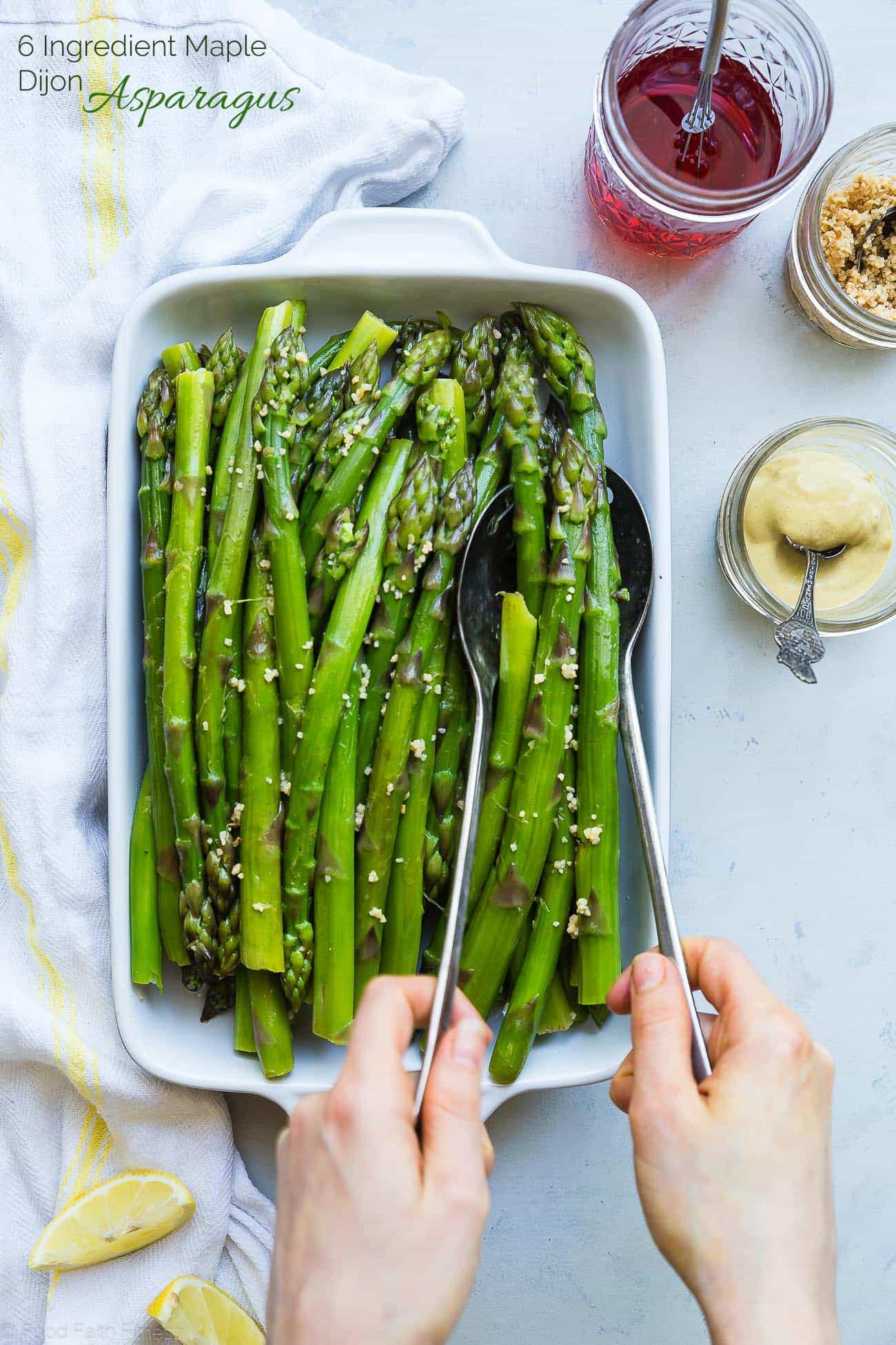 Photograph of hands serving blanched asparagus. Recipe on foodfaithfitness.com