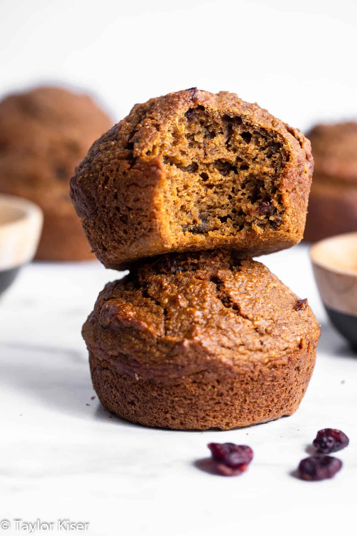 2 healthy gluten free pumpkin muffins stacked on top of each other