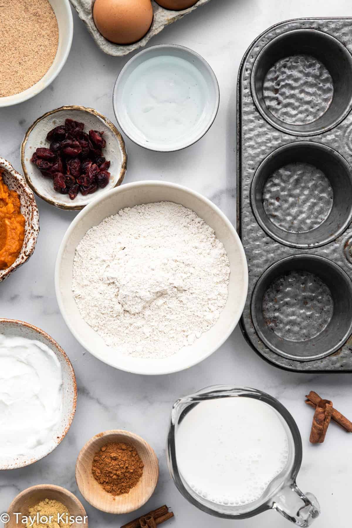 Ingredients to make gluten free pumpkin muffins in bowls