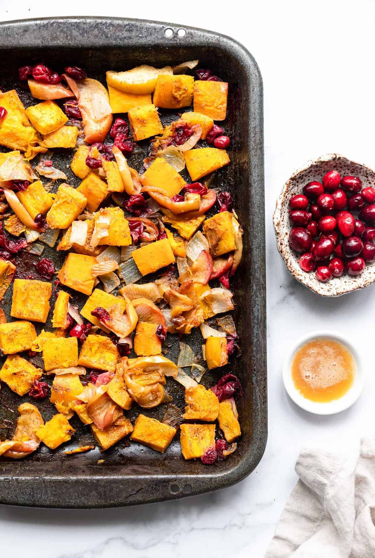 oven roasted pumpkin on a baking sheet with cranberries