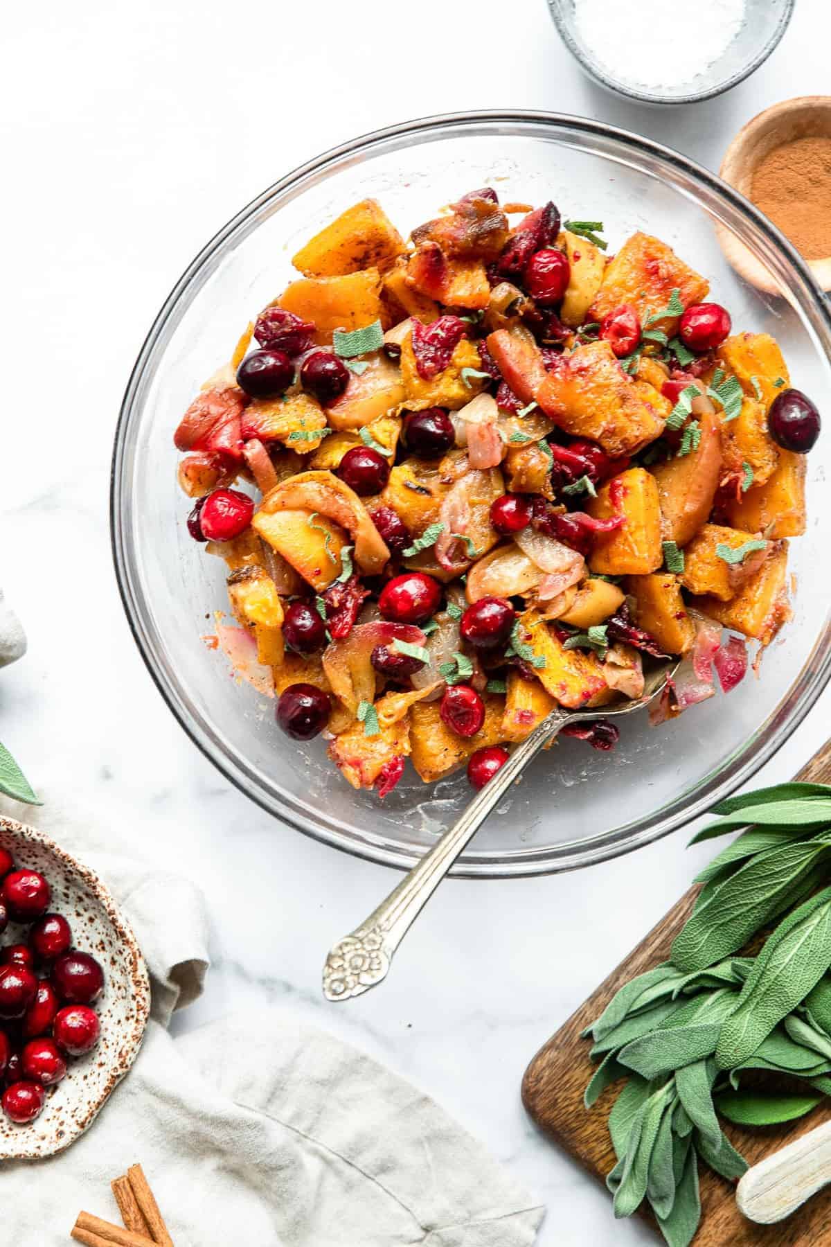 roast pumpkin in a bowl with apples and cranberries