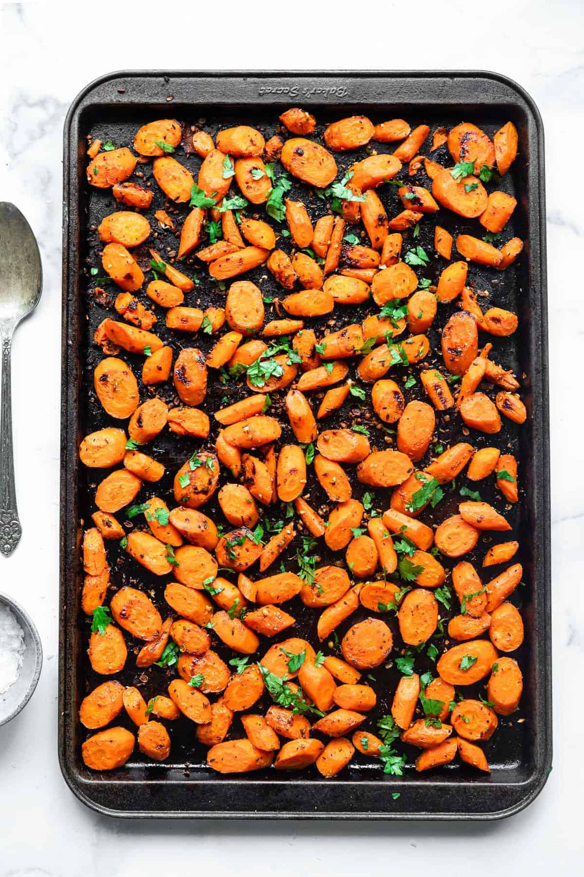 cumin roasted carrots on a sheet pan