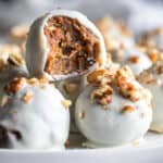 Carrot Cake Truffles on a plate with a bite taken out of one