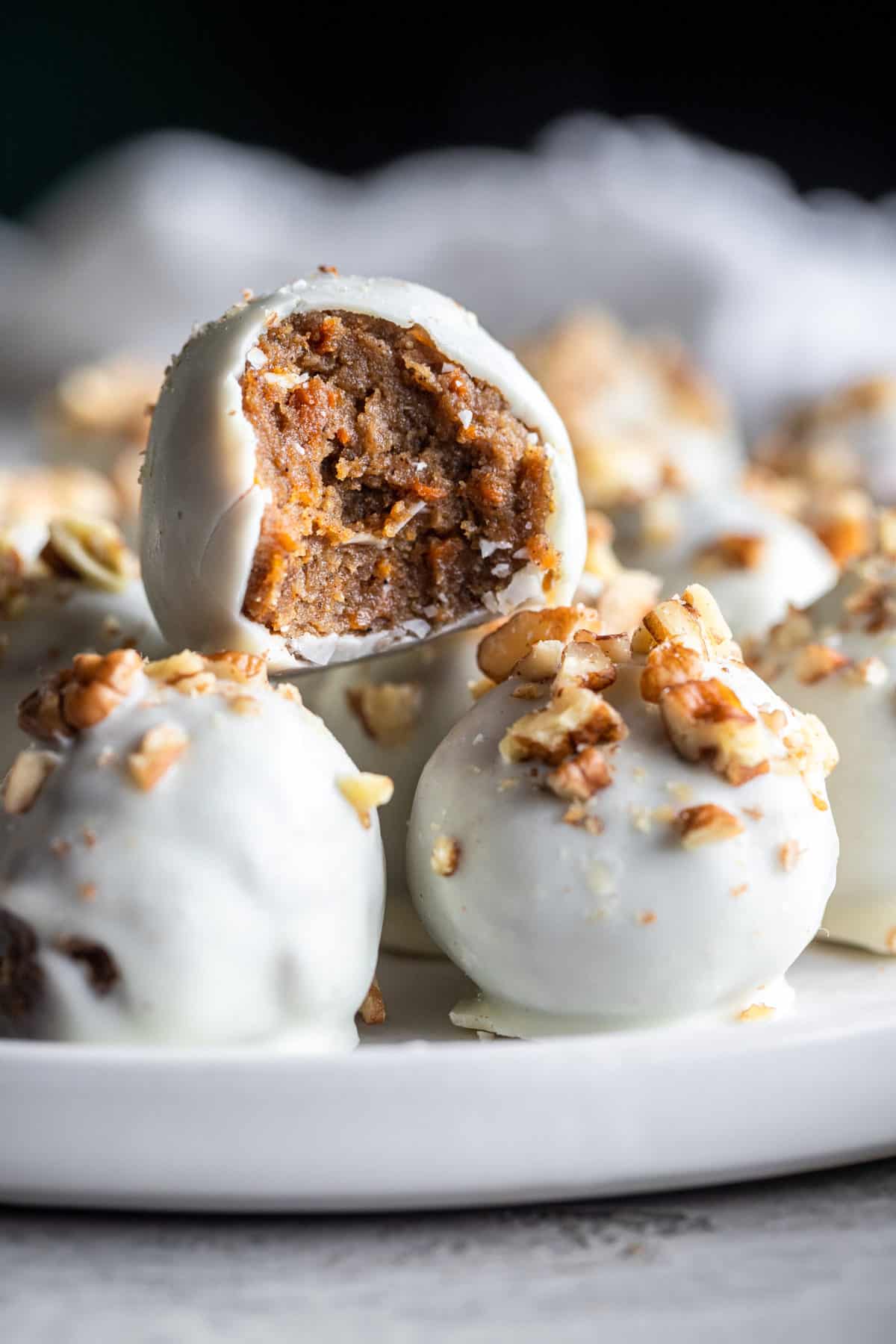 Carrot Cake Truffles on a plate with a bite taken out of one