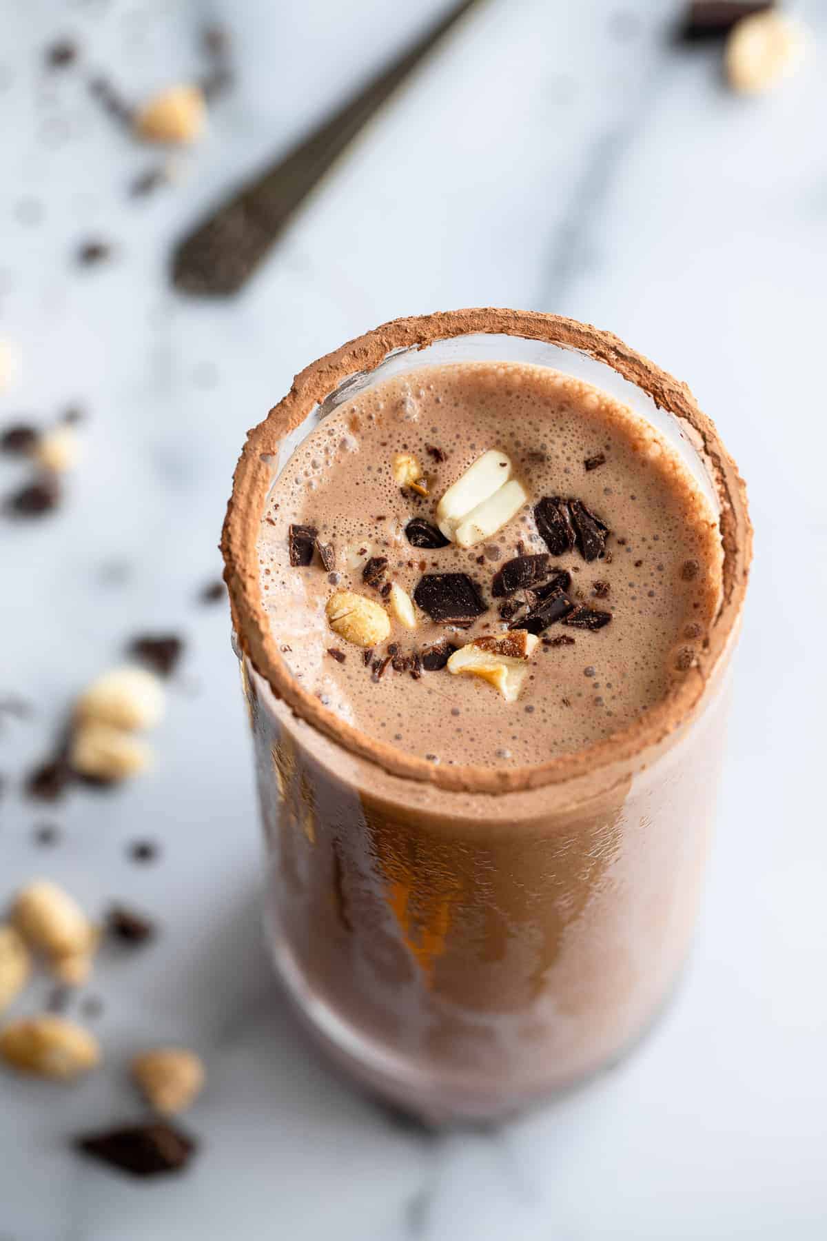Chocolate Protein Shake  in a glass with peanuts on top