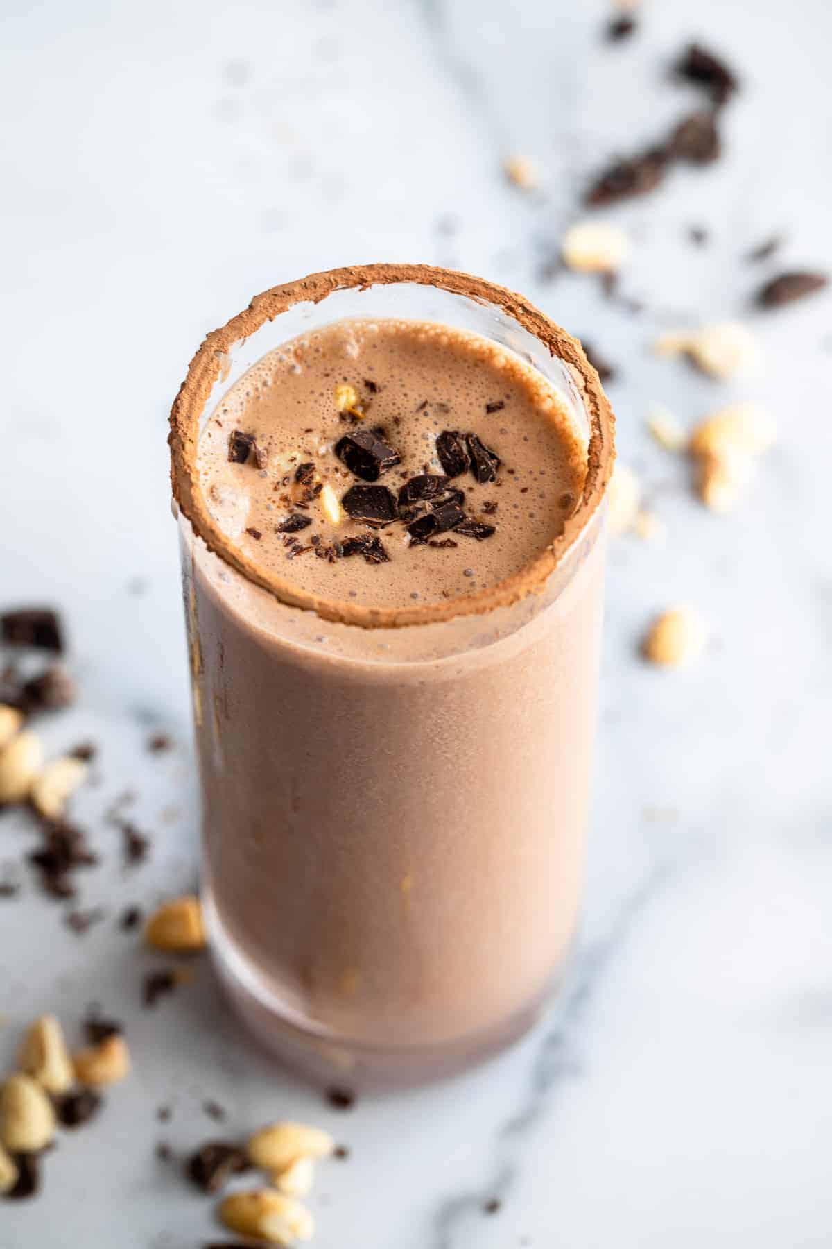 a glass with a Chocolate Protein Shake on a table