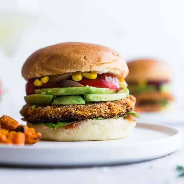 Mexican Sweet Potato Veggie Burgers - These easy homemade sweet potato veggie burgers are made from sweet potatoes coated with crunchy panko and finished with creamy avocado and grilled vegetables! Gluten free, vegan friendly and SERIOUSLY amazing! | #Foodfaithfitness | #Glutenfree #Vegan #Healthy #Veggieburger #DairyFree
