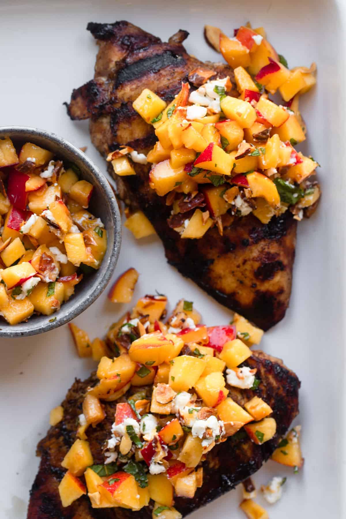 Nectarine Fruit Salsa on chicken on a plate with salsa on the side
