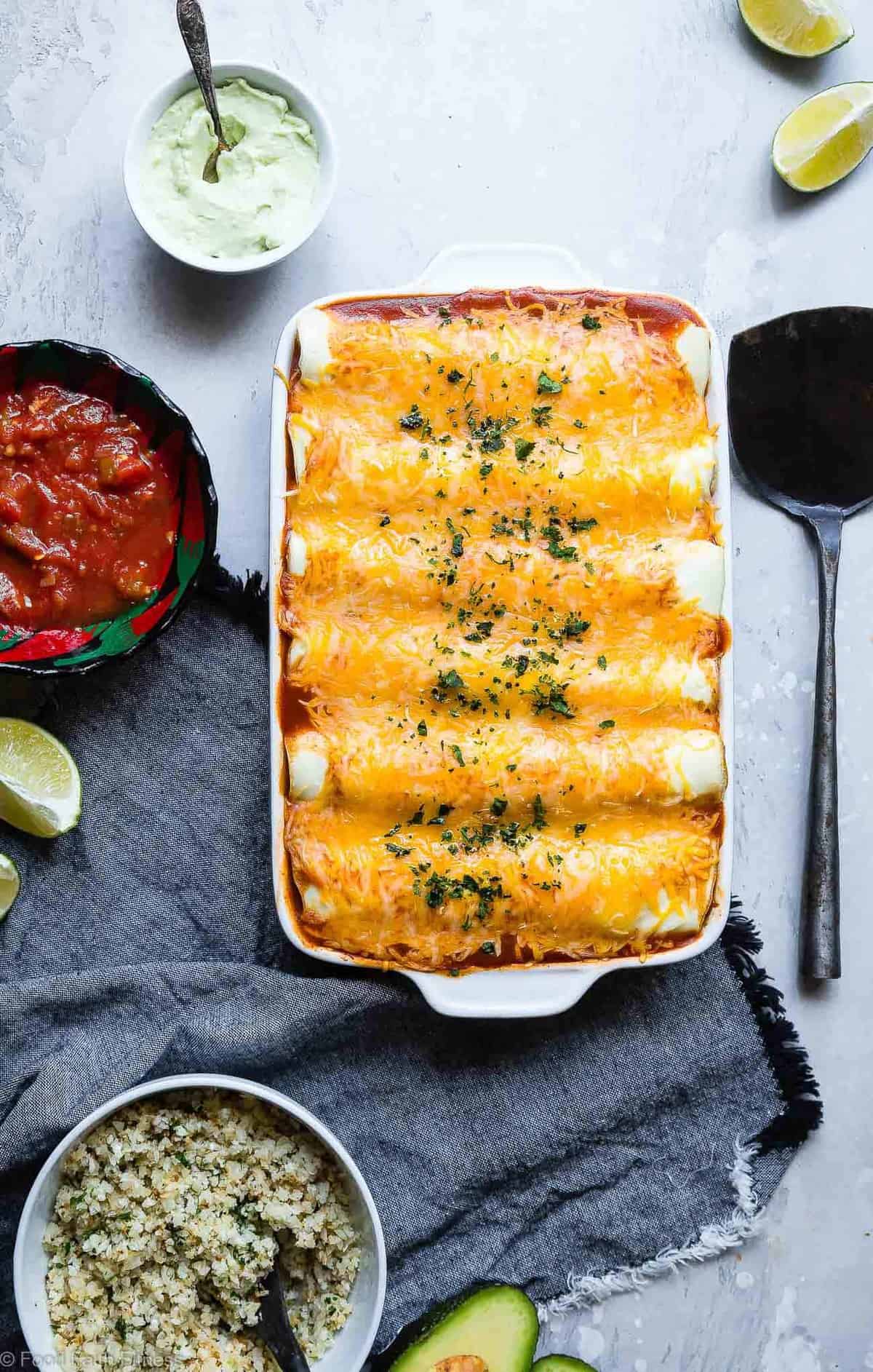 Healthy Low Carb Chicken Enchiladas - This gluten free Healthy Low Carb Chicken Enchilada Recipe uses a secret ingredient to make it low carb, protein PACKED and under 500 calories for a HUGE serving! These do NOT taste healthy and even picky eaters love them! | #Foodfaithfitness | #Lowcarb #Glutenfree #Healthy #Grainfree #Enchiladas 