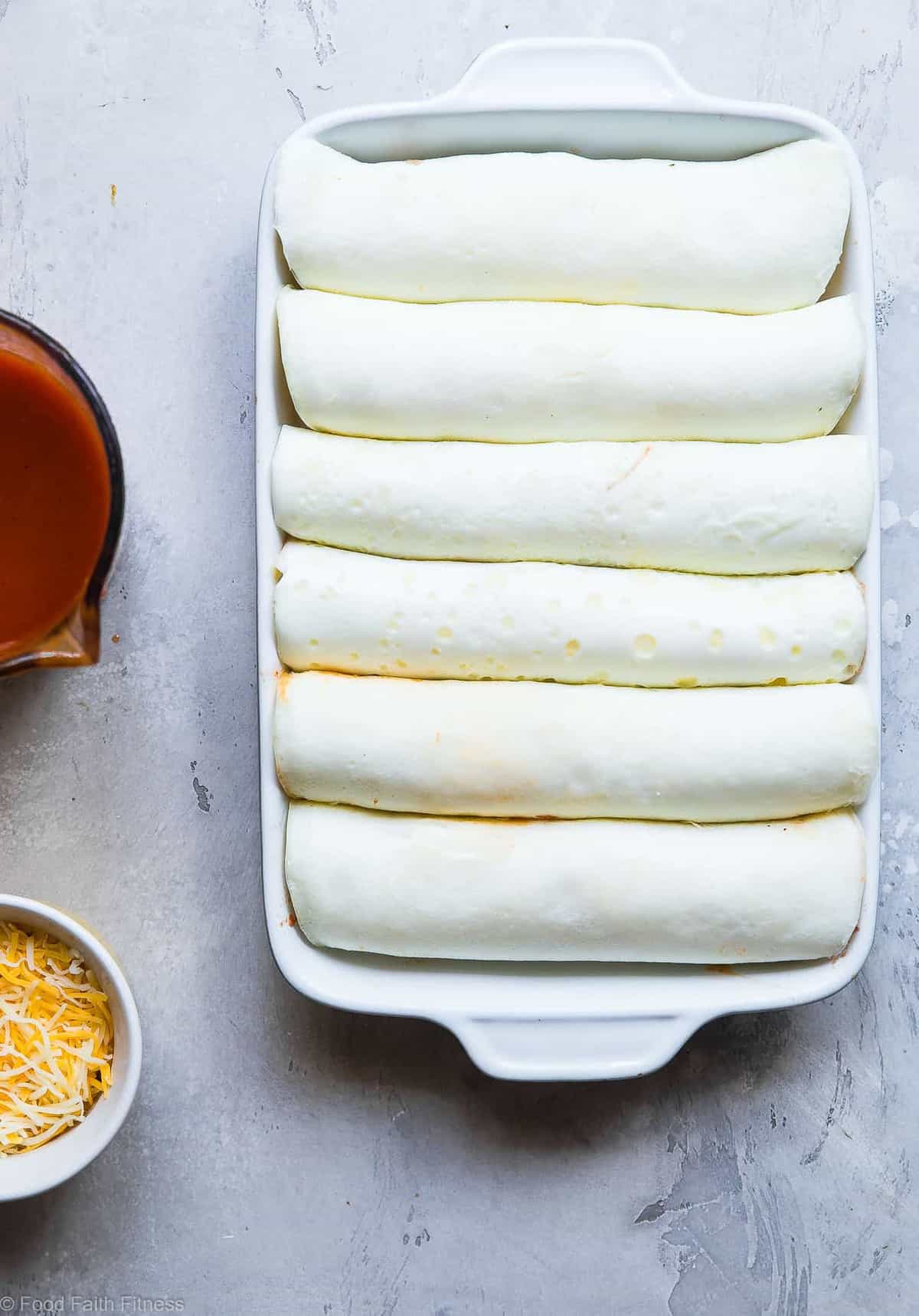 Healthy Low Carb Skinny Chicken Enchiladas - This gluten free Healthy Low Carb Chicken Enchilada Recipe uses a secret ingredient to make it low carb, protein PACKED and under 500 calories for a HUGE serving! These do NOT taste healthy and even picky eaters love them! | #Foodfaithfitness | #Lowcarb #Glutenfree #Healthy #Grainfree #Enchiladas 
