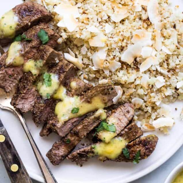 Mango Curry Steak with Coconut Cauliflower Rice - This mango curry steak is served with coconut cauliflower rice for an easy, weeknight dinner that is  under 400 calories, lower carb, gluten free and has bold, addicting flavor! | #Foodfaithfitness | #Glutenfree #Lowcarb #Healthy #Sugarfree #grainfree