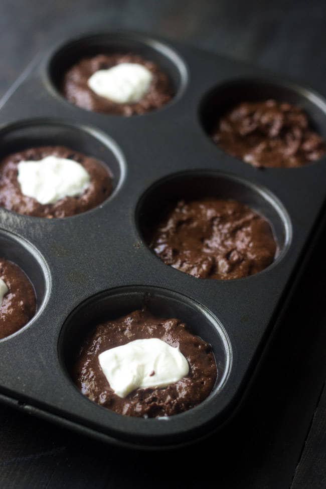 Healthy, Cream-Cheese Filled Chocolate Chip Muffins - Whole wheat and only 150 calories but SO moist and chocolatey! | Foodfaithfitness.com | #muffin #recipe #healthy