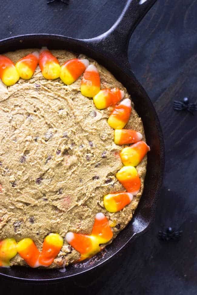 Healthy Halloween Skillet Cookies - 100% Whole Wheat, Butter/oil free and SO thick and chewy. You NEED to try this cookie! | Foodfaithfitness.com | #halloween #skilletcookie #recipe #candycorn