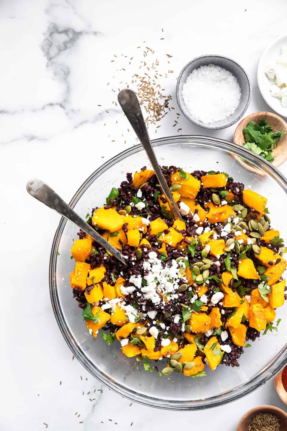 black rice salad with goat cheese in a serving bowl
