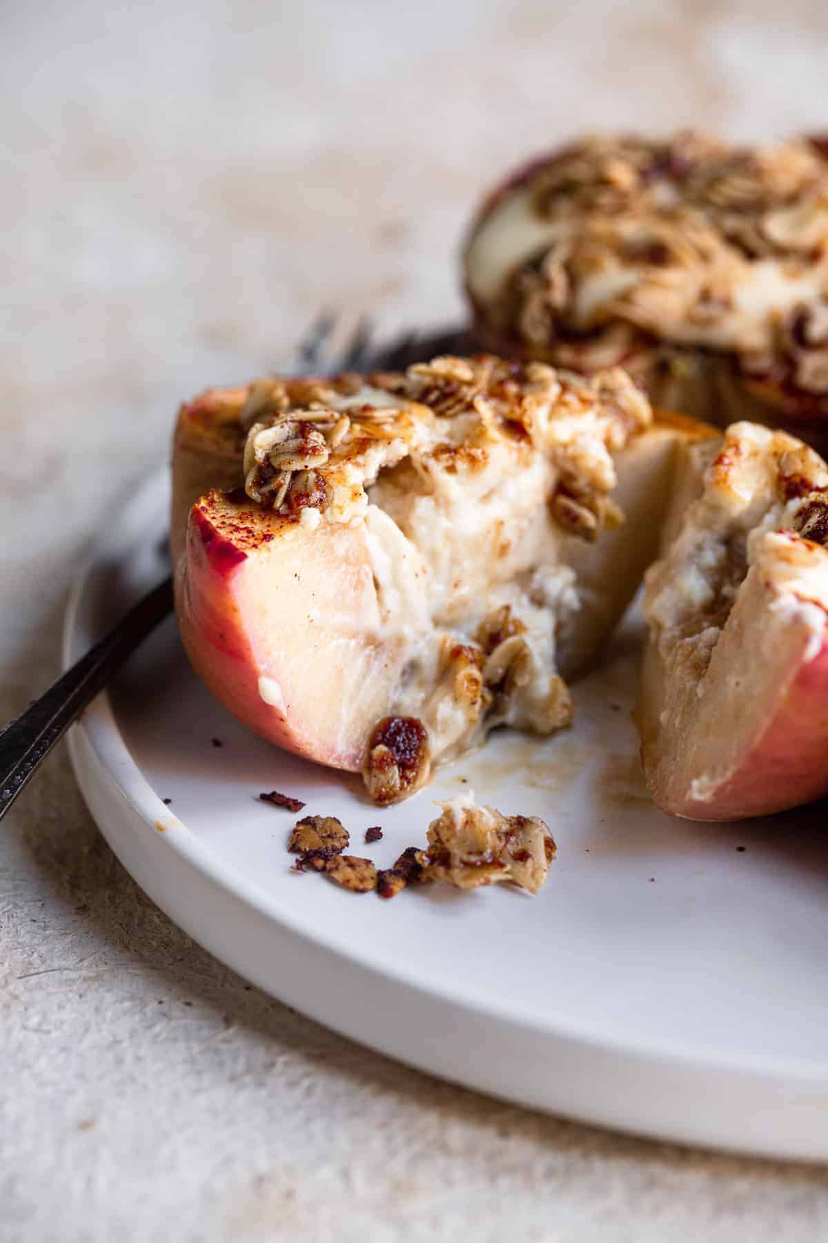 close up of Cheesecake Stuffed Apples on a plate with crumble on top
