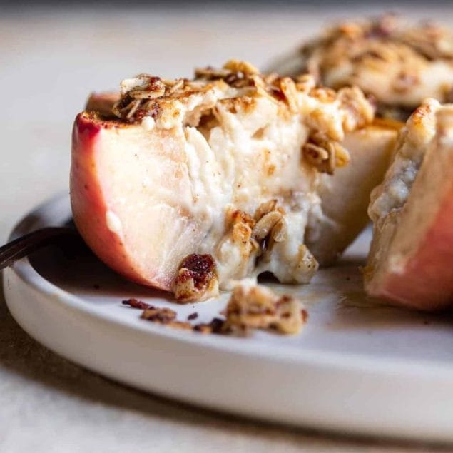 cut open Cheesecake Stuffed Apples on a plate