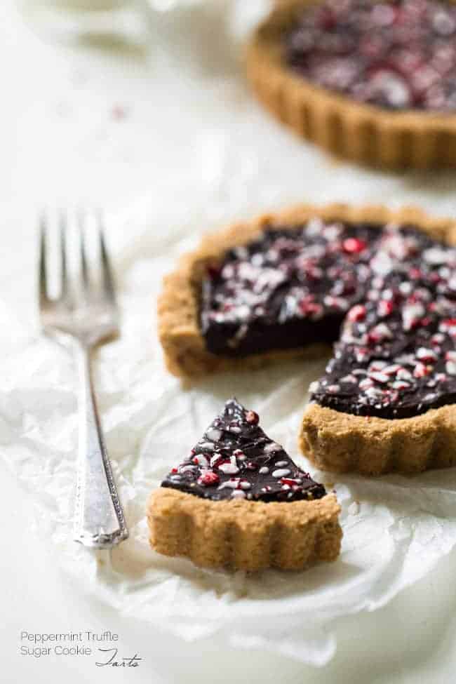 Gluten Free Sugar Cookie Tarts with Peppermint Truffle Filling - Healthier tarts that are SO rich, creamy and easy to make! They'll be a huge hit at Christmas! | Foodfaithfitness.com | #recipe