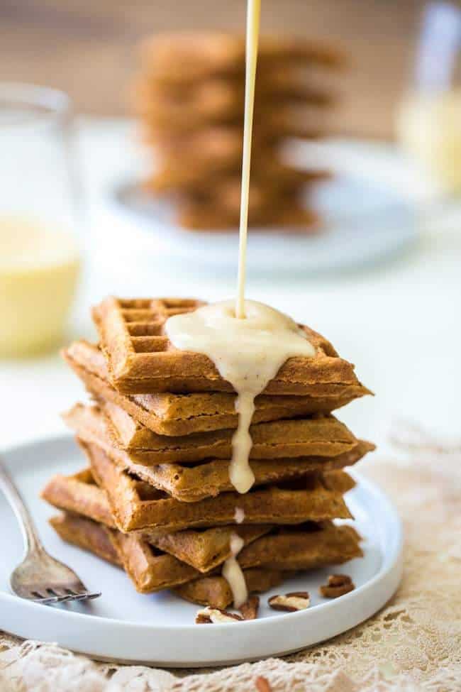 The Best Waffles with Eggnog Cream Sauce - Seriously. These are absolutely AMAZING! Light, crispy and perfect for Christmas morning! | Foodfaithfitness.com | #recipe
