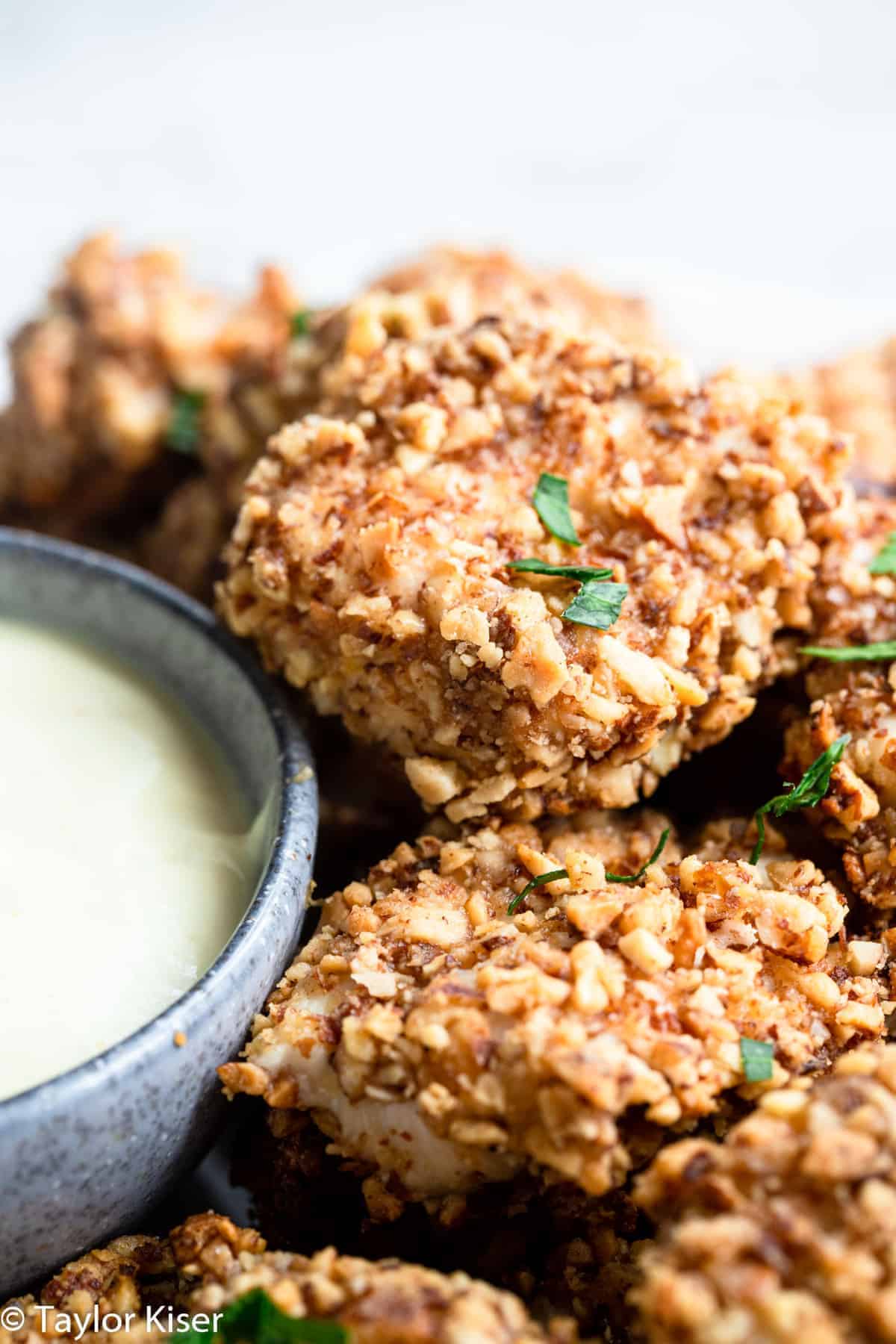 stack of almond crusted chicken bites on a plate