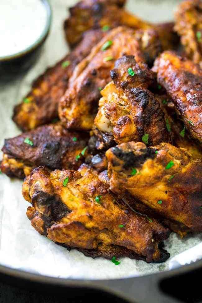 Tandoori Crispy Baked Chicken Wings - Marinated in Greek yogurt and baked, not fried, these super easy chicken wings.with a little Indian spice, are a healthier crowd pleaser! | Foodfaithfitness.com | #recipe