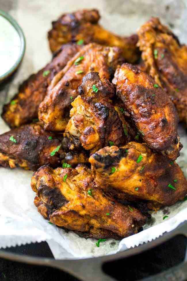 Tandoori Crispy Baked Chicken Wings - Marinated in Greek yogurt and baked, not fried, these super easy chicken wings.with a little Indian spice, are a healthier crowd pleaser! | Foodfaithfitness.com | #recipe