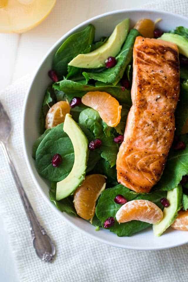 Superfood Kale & Salmon Salad With Coconut Orange Vinaigrette - A simple salad with 7 different superfoods that is so easy and paleo friendly! Perfect for a healthy, weeknight meal! | Foodfaithfitness.com | #recipe