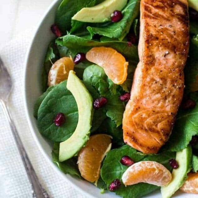 Superfood Kale & Salmon Salad With Coconut Orange Vinaigrette - A simple salad with 7 different superfoods that is so easy and paleo friendly! Perfect for a healthy, weeknight meal! | Foodfaithfitness.com | #recipe