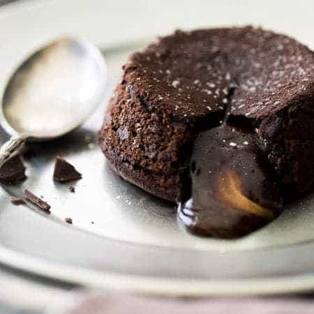 Paleo Chocolate Lava Cake Recipe - So rich and chocolatey that you would NEVER know these are healthy! They’re made with coconut oil and almond butter, so they taste like an Almond Joy bar! Perfect for Valentine’s Day!