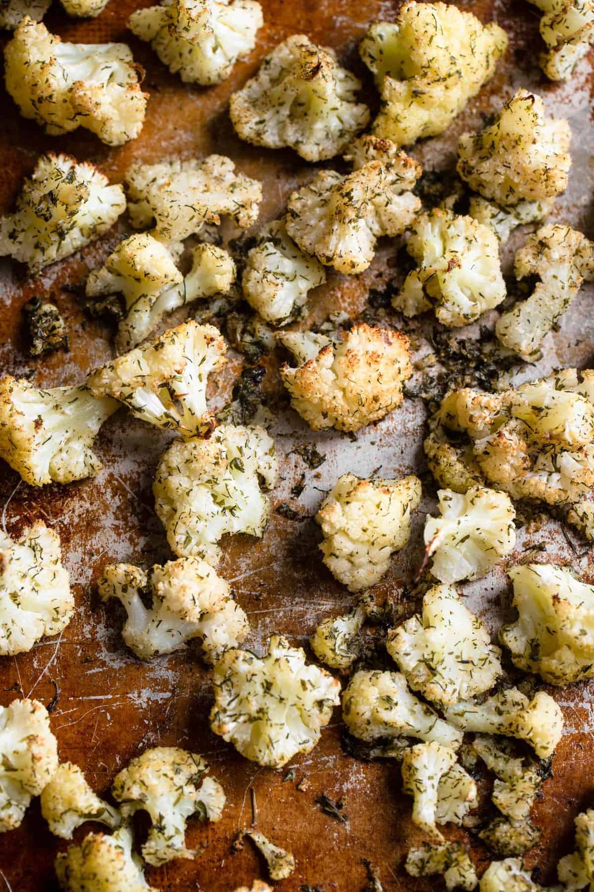 close up of ranch cauliflower being roasted on a baking sheet