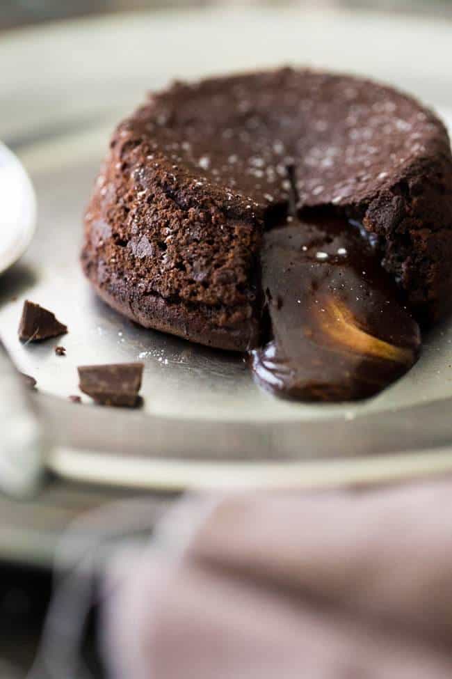 Paleo Chocolate Lava Cake Recipe - So rich and chocolatey that you would NEVER know these are healthy! They’re made with coconut oil and almond butter, so they taste like an Almond Joy bar! Perfect for Valentine’s Day! | Foodfaithfitness.com |