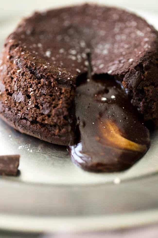 Paleo Chocolate Lava Cake Recipe - So rich and chocolatey that you would NEVER know these are healthy! They’re made with coconut oil and almond butter, so they taste like an Almond Joy bar! Perfect for Valentine’s Day! | Foodfaithfitness.com |
