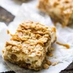 Healthier Oatmeal Crumble Peanut Butter Cheesecake Bars - SO easy to make and always a hit at gatherings! So creamy that you would never know they're lightened up with Greek yogurt and whole wheat flour! | Foodfaithfitness.com | @FoodFaithFit