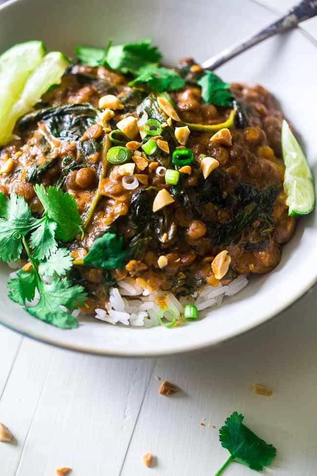 One-Pot Creamy Spinach Lentils - These Thai-style lentils are stewed in creamy peanut butter and coconut milk. They're a vegetarian, one pot wonder that is perfect for Meatless Monday! | Foodfaithfitness.com | @FoodFaithFit