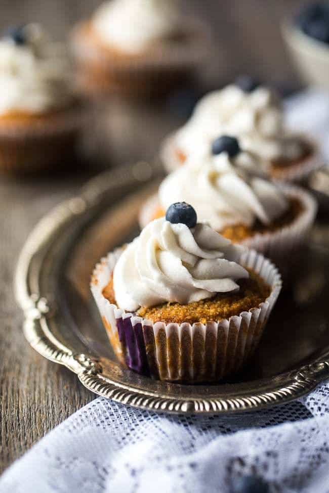 The BEST Gluten Free Cupcake Recipe with Blueberries – These cupcakes mixed with fresh blueberries and topped with coconut cream are a healthier, Paleo-friendly dessert that is perfect for Summer! | Foodfaithfitness.com | @FoodFaithFit