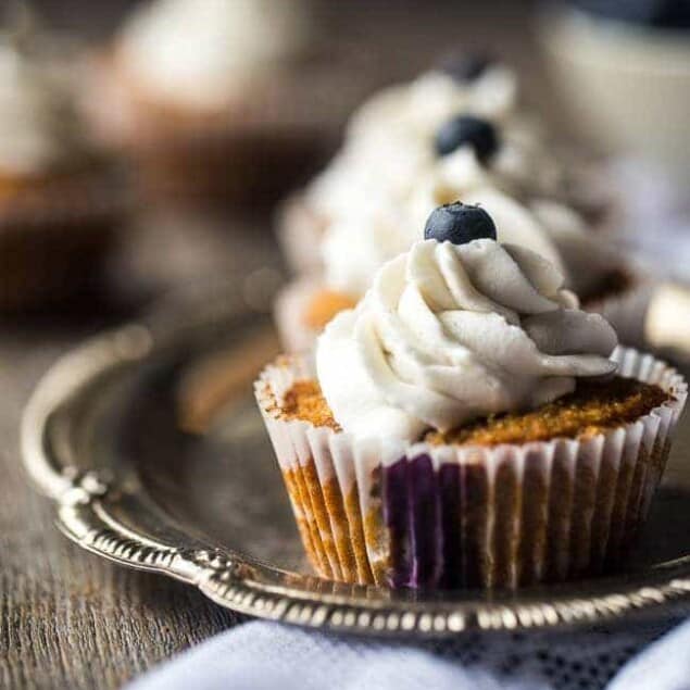 Blueberry Gluten Free Cupcakes with Coconut Cream – These cupcakes mixed with fresh blueberries and topped with coconut cream are a healthier, Paleo-friendly dessert that is perfect for Summer! | Foodfaithfitness.com | @FoodFaithFit