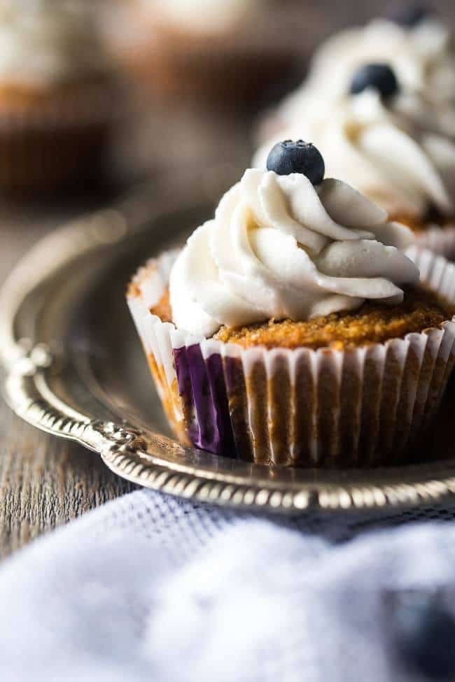The BEST Gluten Free Cupcake Recipe with Blueberries – These gluten free cupcakes for kids are mixed with fresh blueberries and topped with coconut cream are a healthier, Paleo-friendly dessert that is perfect for Summer! | Foodfaithfitness.com | @FoodFaithFit