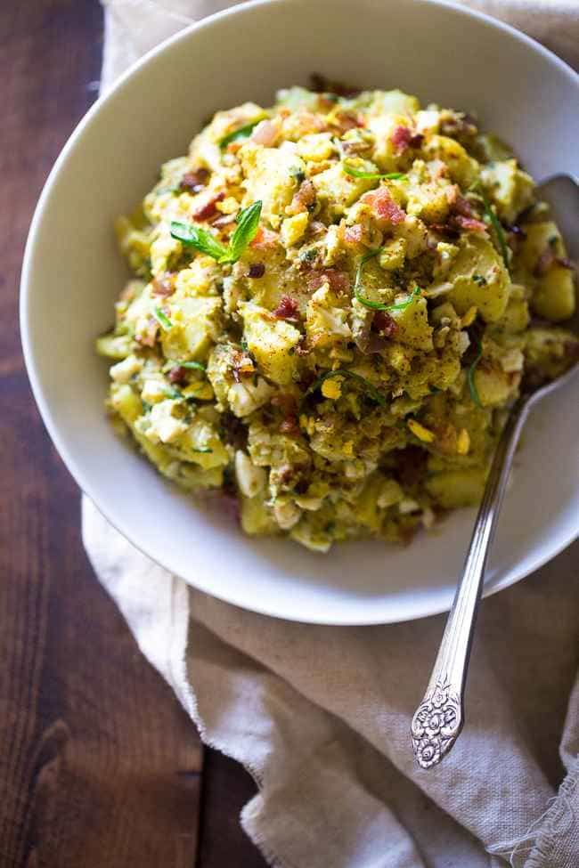 Paleo Sweet Potato Salad with Bacon, Eggs and Avocado Pesto – A healthy side dish that is SUPER creamy, easy to make and always a crowd pleaser! You won’t even miss the mayonnaise! | Foodfaithfitness.com | @FoodFaithFit