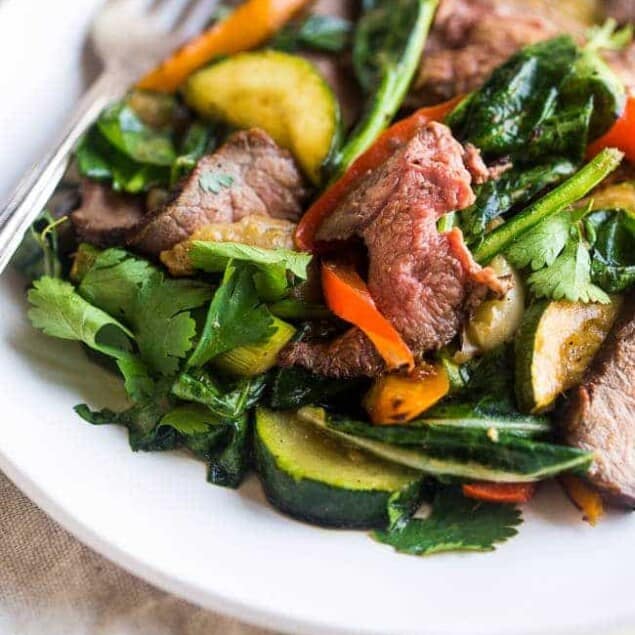Paleo Grilled Beef Stir Fry with Asian Almond Dressing- Beef and veggies are grilled and then tossed with a creamy Asian almond butter vinaigrette and spinach for a quick and easy, healthy, Paleo-friendly meal! | Foodfaithfitness.com | @FoodFaithFit