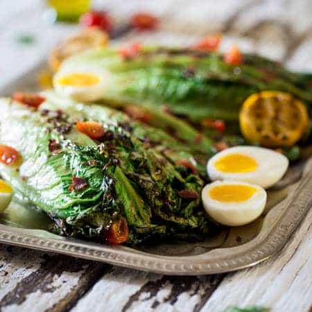 BLT Grilled Wedge Salads with Lemon Dill Vinaigrette - Grilled romaine hearts are tossed with turkey bacon, tomato, soft boiled eggs and a creamy, homemade lemon dill dressing! It's a low carb, healthy summer meal for 300 calories! | Foodfaithfitness.com | @FoodFaithFit