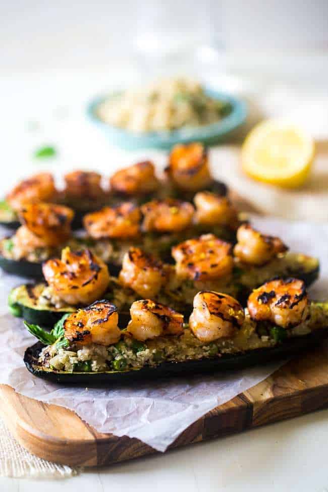 side view of shrimp zucchini boats on a cutting board