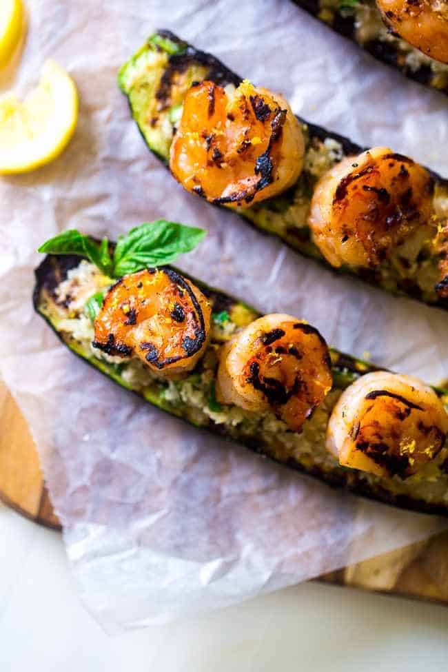 over head view of shrimp zucchini boats with lemon on the side