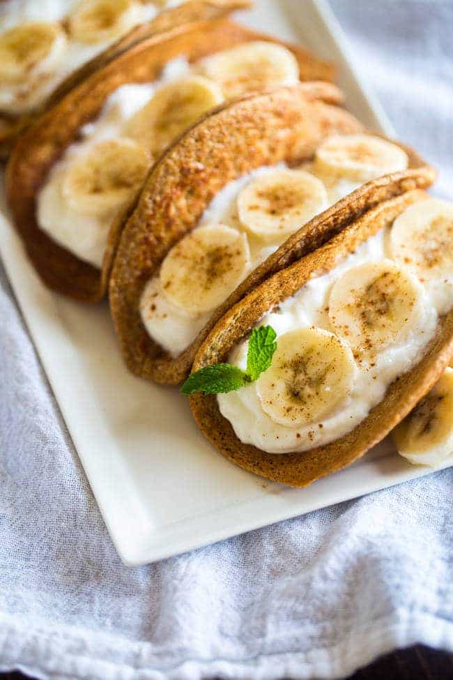 Greek Yogurt Banana Pancake Tacos - These gluten free banana pancakes are filled with Greek yogurt and rolled up like tacos! They're a fun, healthy breakfast for only 100 calories per taco! | Foodfaithfitness.com | @FoodFaithFit