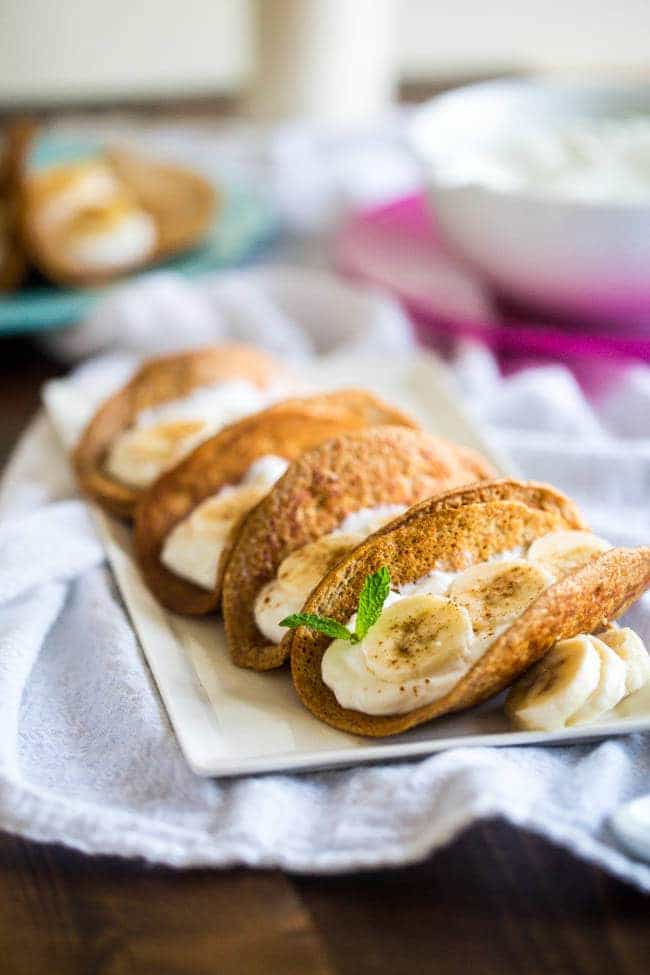Greek Yogurt Banana Pancake Tacos - These gluten free banana pancakes are filled with Greek yogurt and rolled up like tacos! They're a fun, healthy breakfast for only 100 calories per taco! | Foodfaithfitness.com | @FoodFaithFit