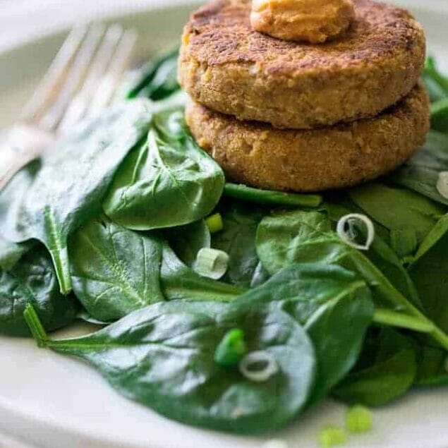 6 Ingredient Vegan Cauliflower Fritters With Hummus - Chickpeas and cauliflower are blended together, pan fried and topped with hummus so they're crispy on the outside and creamy on the inside. A quick, easy and healthy meatless Monday meal for under 350 calories! | Foodfaithfitness.com | @FoodFaithFit