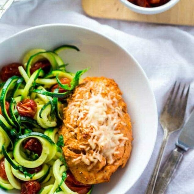 Sun-Dried Tomato Chicken with Zucchini Noodles - Zucchini noodles are tossed with roasted tomatoes, lemon, basil and Parmesan, then topped with sun-dried tomato & Greek yogurt marinated chicken for an easy, healthy weeknight meal that's under 350 calories! | Foodfaithfitness.com | @FoodFaithFit